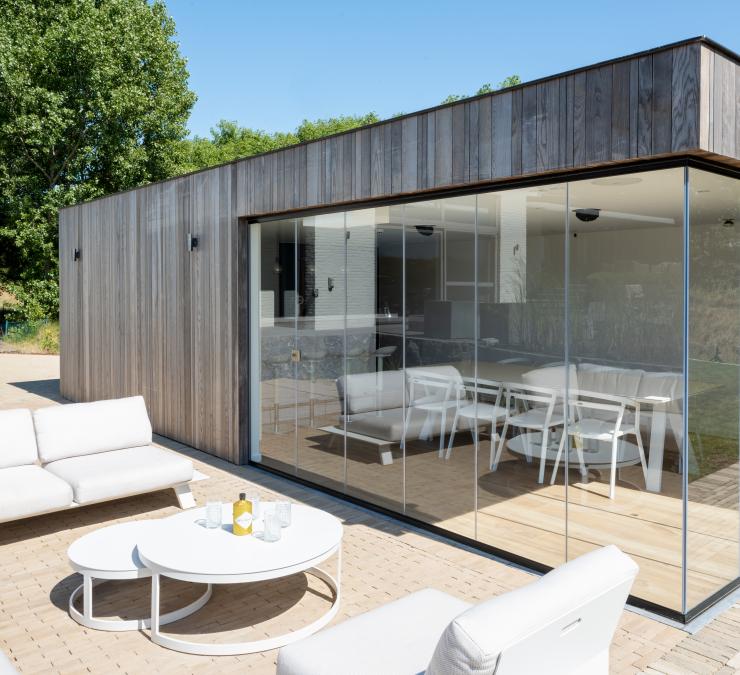 Modern pool house with large sliding glass panels