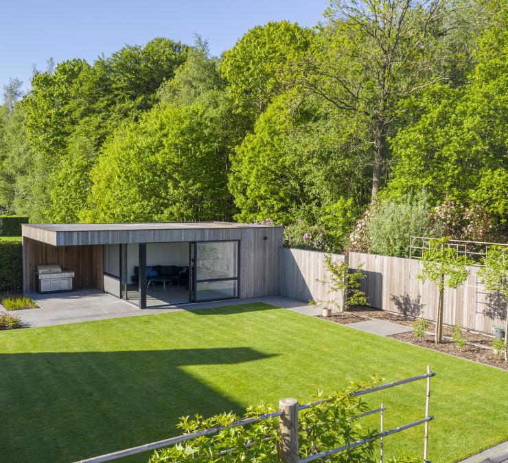 Houten omheining naast bijgebouw in thermisch essen Plus line QC