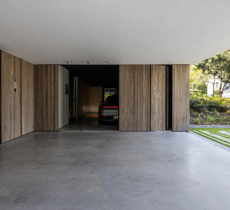 Moderne garage met afwerking in essen hout verticale profielen in Nederland.