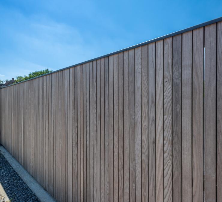 Wooden sliding gate clad in Fine line QC HOTwood ash on one side