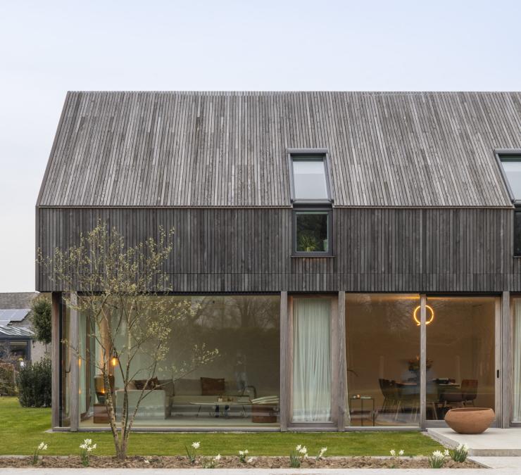 The timber cladding adds warmth to this modern house in a rural setting